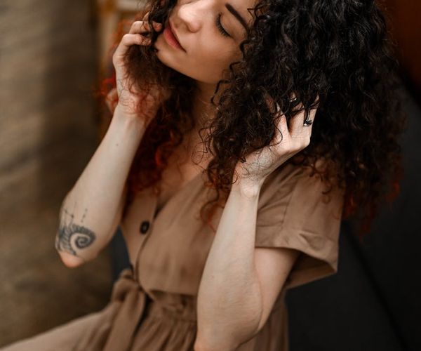 Person sitting in a calm meditation pose with a serene expression.